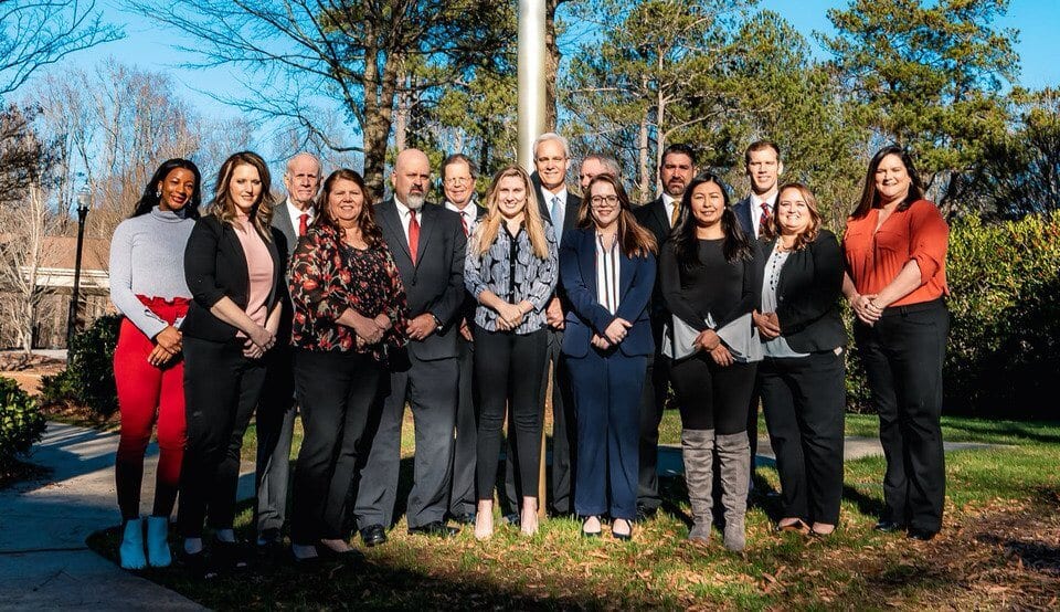 Howe Law injury and accident lawyer team posing outdoors in Atlanta