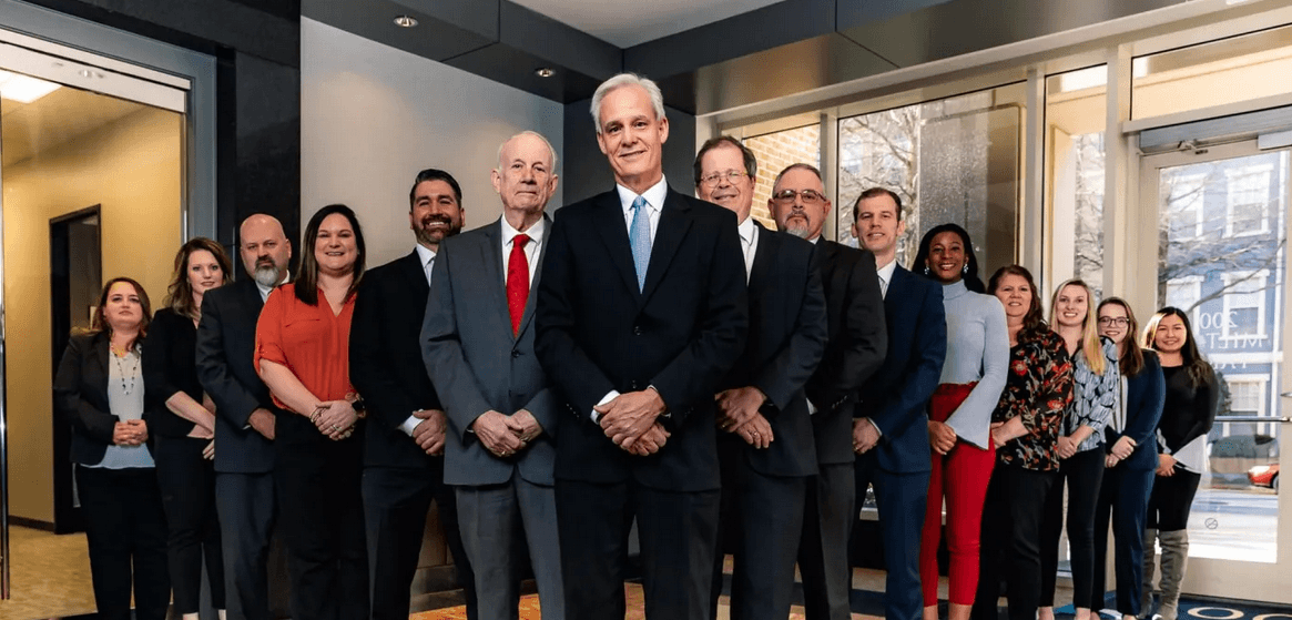 Howe Law injury and accident lawyer team standing in office lobby