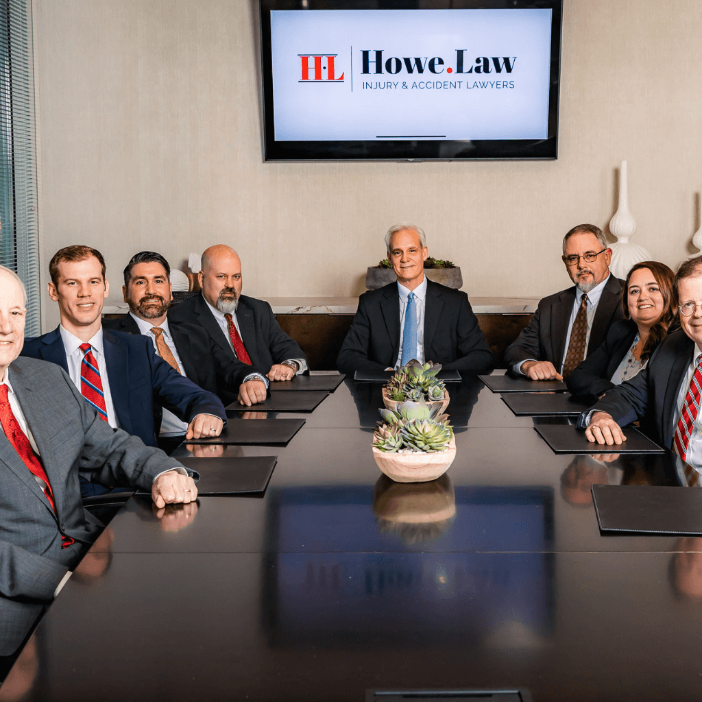 Howe Law injury and accident lawyers team seated around conference room table